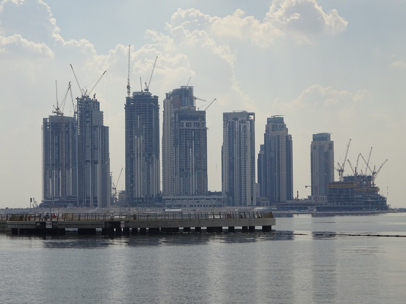 Towers under construction on Dubai Creek with cranes