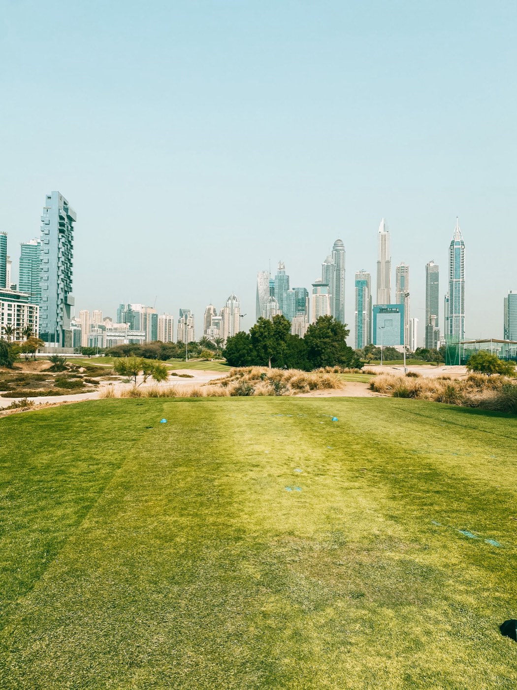 Golf fairway with the Dubai skyline behind